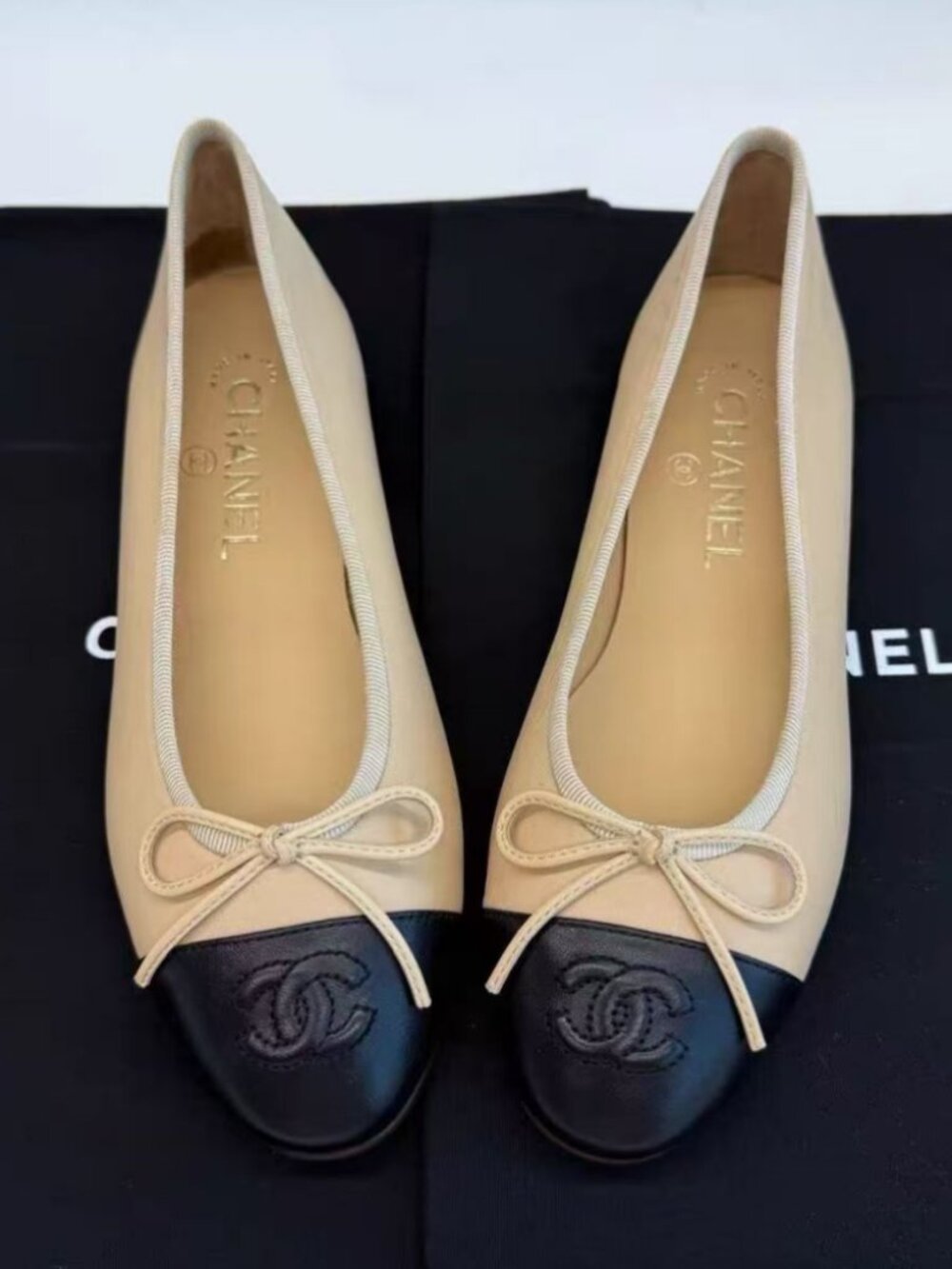 CHANEL Beige Black Cap‑Toe Bow Ballet Flats